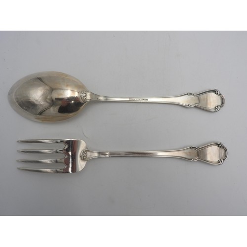 437 - A PERUVIAN SILVER SERVING SPOON AND FORK by Camusso, stamped Sterling 925, with lotus flower detaili... 