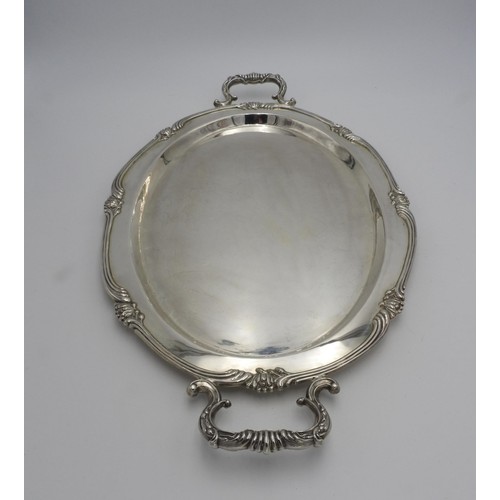 438 - A LARGE PERUVIAN SILVER OVAL TWO HANDLED TRAY BY CAMUSSO, with lotus flower detailing to the rim, sc... 