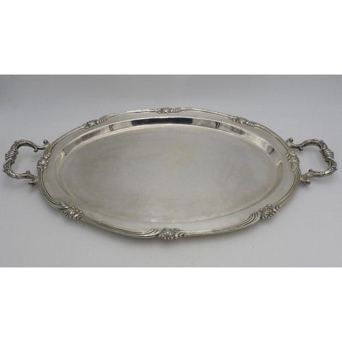 438 - A LARGE PERUVIAN SILVER OVAL TWO HANDLED TRAY BY CAMUSSO, with lotus flower detailing to the rim, sc... 