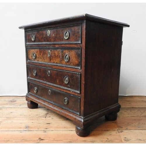 88 - A 19TH CENTURY MAHOGANY AND WALNUT CHEST OF FOUR DRAWERS ON BUN FEET, with brass ring handles, 61 x ... 