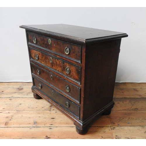 88 - A 19TH CENTURY MAHOGANY AND WALNUT CHEST OF FOUR DRAWERS ON BUN FEET, with brass ring handles, 61 x ... 