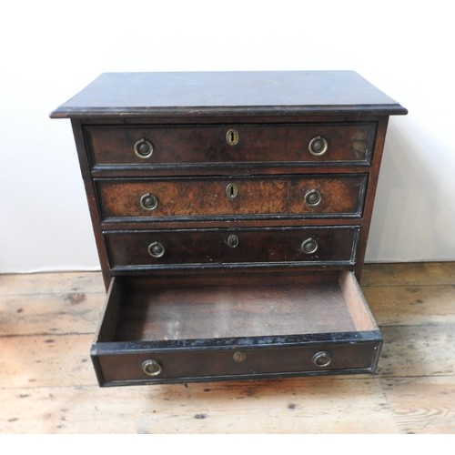 88 - A 19TH CENTURY MAHOGANY AND WALNUT CHEST OF FOUR DRAWERS ON BUN FEET, with brass ring handles, 61 x ... 