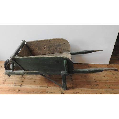 92 - A FRENCH RUSTIC GREEN PAINTED WHEELBARROW, the original wheel replaced with a later addition, 63 x 1... 