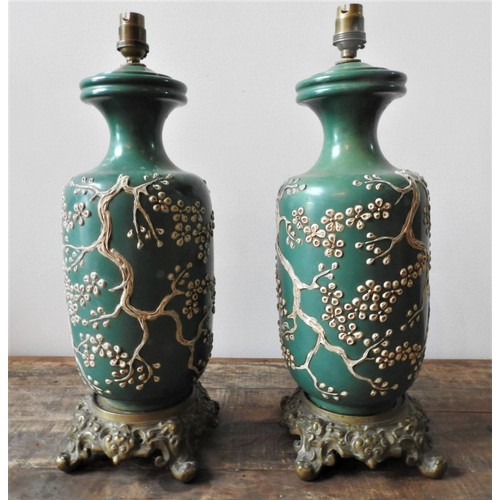 121 - A PAIR OF 19th CENTURY CHINESE GREEN GLAZED TABLE LAMPS,  EMBOSSED WITH BLOSSOM PATTERN ON ORNATE BR... 