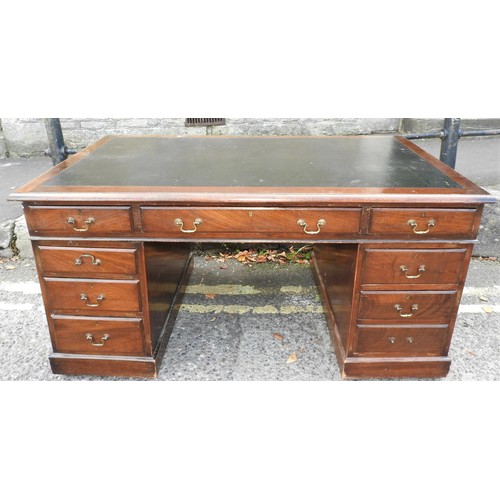 461 - AN OAK DOUBLE PEDESTAL LEATHER TOP WRITING DESK, with seven short drawers and central long drawer, w... 