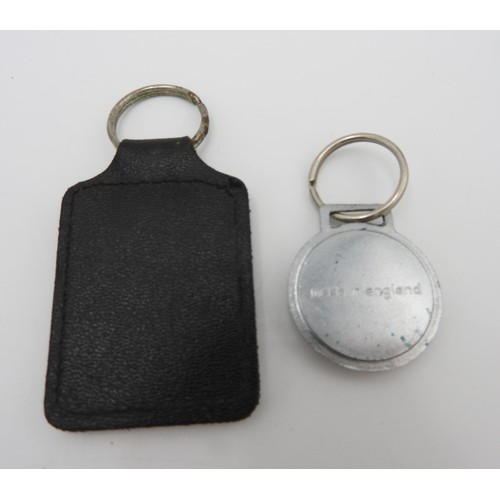 40 - ONE FERRARI KEYRING WITH LEATHER FOB AND ONE ROUND FERRARI KEYRINGThese are original dealer items fr... 