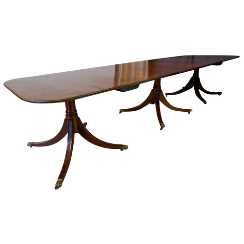 3 - MAHOGANY TRIPLE PILLAR DINING TABLE, BY JONATHAN SAINSBURYwith two leaf insertions, the d-shaped top... 