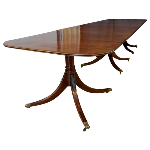 3 - MAHOGANY TRIPLE PILLAR DINING TABLE, BY JONATHAN SAINSBURYwith two leaf insertions, the d-shaped top... 