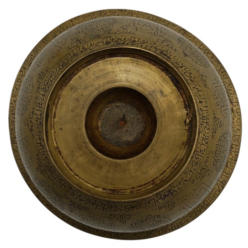 370 - ISLAMIC BRASS MAGIC BOWL19TH CENTURYthe bowl engraved throughout with bands of Koranic script21cm di... 