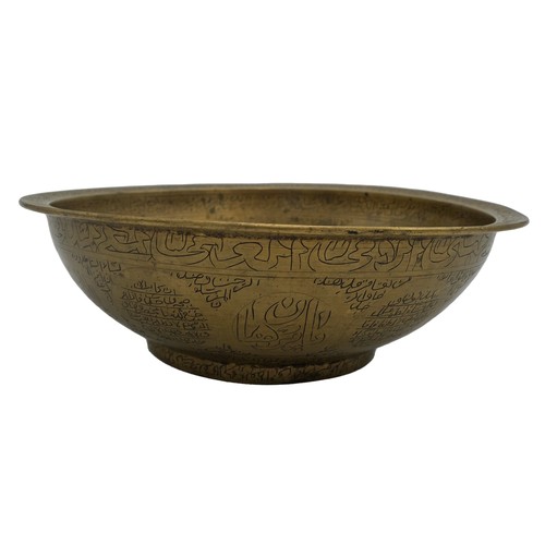 370 - ISLAMIC BRASS MAGIC BOWL19TH CENTURYthe bowl engraved throughout with bands of Koranic script21cm di... 