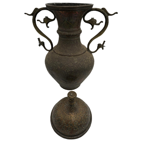 373 - LARGE ISLAMIC COPPER COVERED URN19TH CENTURYwith a domed lid and twin scroll handles, the sides deco... 