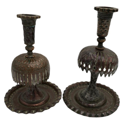 379 - TWO PERSIAN TINNED COPPER CANDLESTICKS19TH CENTURY raised on a wide dished circular foot19cm & 2... 