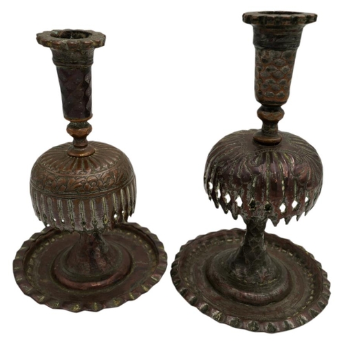 379 - TWO PERSIAN TINNED COPPER CANDLESTICKS19TH CENTURY raised on a wide dished circular foot19cm & 2... 