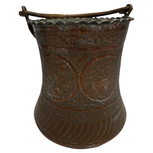 383 - LARGE PERSIAN TINNED COPPER CAULDRON19TH CENTURYwith swing handle, the sides decorated in relief wit... 