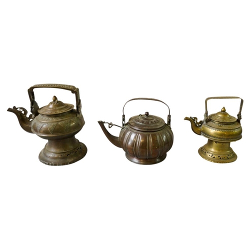 394 - THREE SOUTH EAST ASIAN BRASS WATER KETTLES19TH CENTURYlargest, 27cm high, smallest, 22cm highPROVENA... 