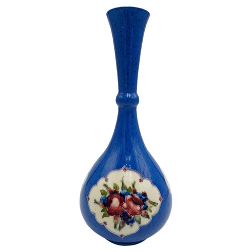 216 - WILLIAM MOORCROFT POWDER-BLUE BOTTLE VASECIRCA 1920the body decorated with floral filled panels, res... 