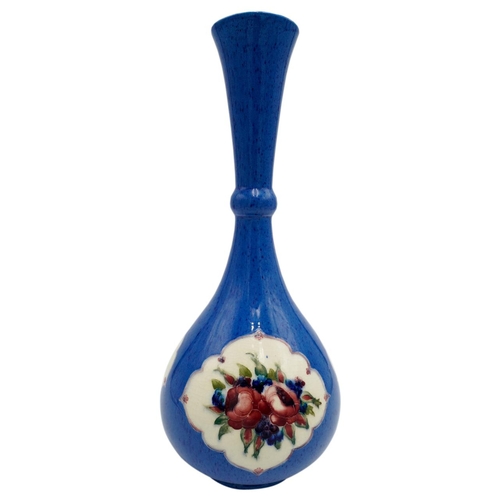 216 - WILLIAM MOORCROFT POWDER-BLUE BOTTLE VASECIRCA 1920the body decorated with floral filled panels, res... 