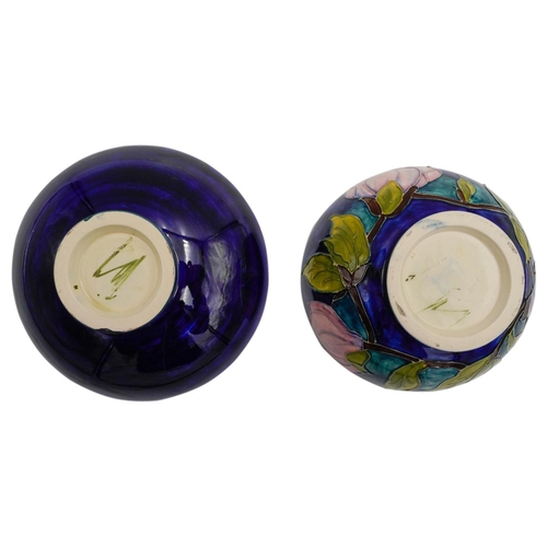 222 - TWO MOORCROFT MAGNOLIA PATTERN BOWLSdecorated with magnolias against a blue ground, painted and impr... 