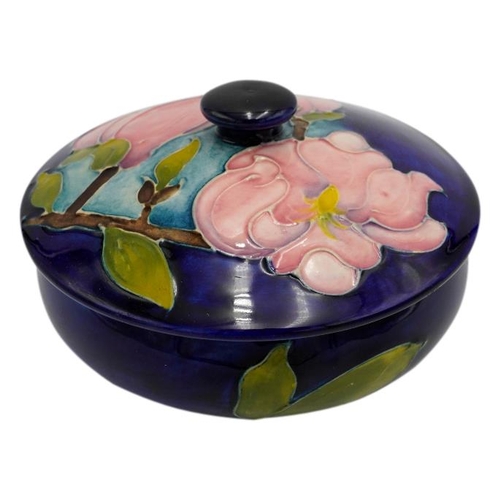 224 - TWO MOORCROFT MAGNOLIA PATTERN BOXESeach decorated with blossoming magnolias on a blue ground, impre... 