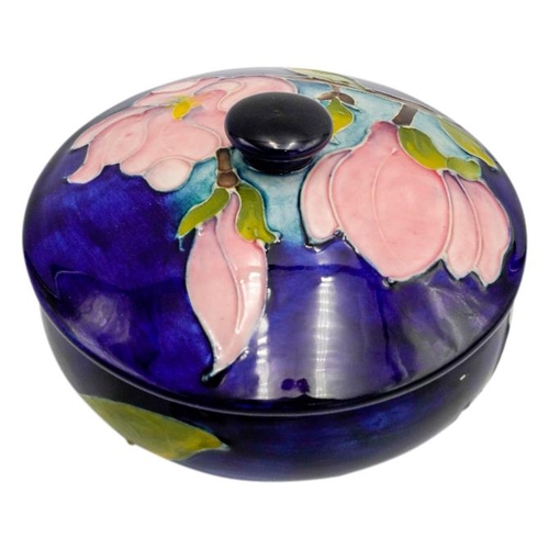 224 - TWO MOORCROFT MAGNOLIA PATTERN BOXESeach decorated with blossoming magnolias on a blue ground, impre... 