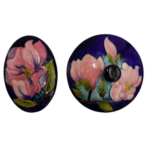 224 - TWO MOORCROFT MAGNOLIA PATTERN BOXESeach decorated with blossoming magnolias on a blue ground, impre... 