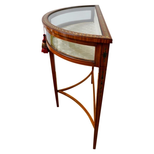 36 - EDWARDIAN PAINTED SATINWOOD DEMI LUNE VITRINECIRCA 1910the glazed hinged top enclosing a lined inter... 