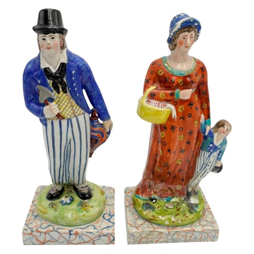 186 - PAIR OF PEARLWARE FIGURESCIRCA 1820depicting a woodsman, his wife and child, raised on marbleised ba... 