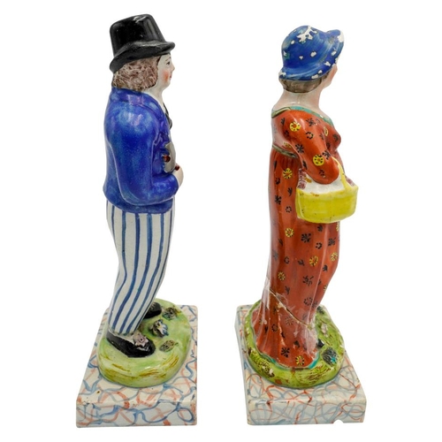 186 - PAIR OF PEARLWARE FIGURESCIRCA 1820depicting a woodsman, his wife and child, raised on marbleised ba... 