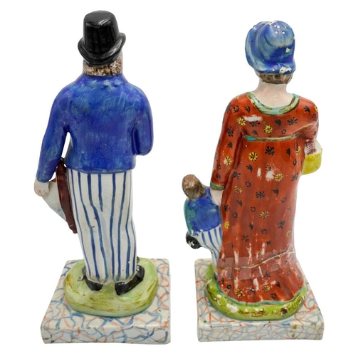 186 - PAIR OF PEARLWARE FIGURESCIRCA 1820depicting a woodsman, his wife and child, raised on marbleised ba... 