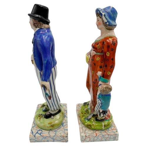 186 - PAIR OF PEARLWARE FIGURESCIRCA 1820depicting a woodsman, his wife and child, raised on marbleised ba... 