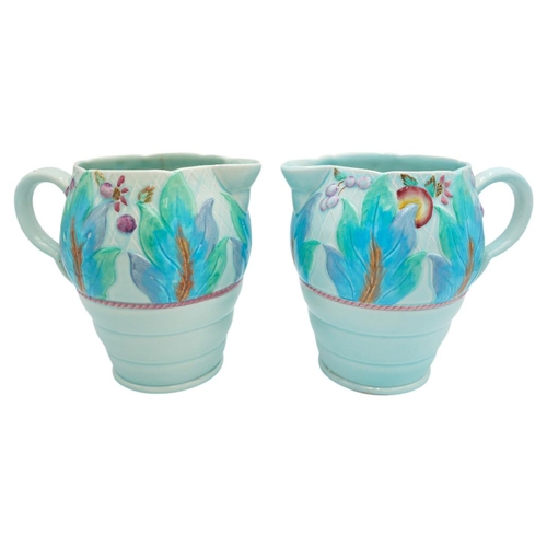 189 - TWO CLARICE CLIFF NEWPORT POTTERY MOULDED JUGSdecorated with a band of leaves and fruit, green print... 