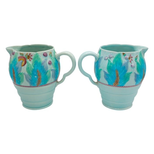 189 - TWO CLARICE CLIFF NEWPORT POTTERY MOULDED JUGSdecorated with a band of leaves and fruit, green print... 