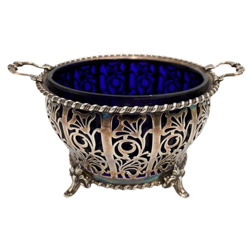 492 - SILVER SUGAR BASKETCHESTER 1939with a blue glass liner15cm wide170 grams.PROVENANCE : Private Oxford... 