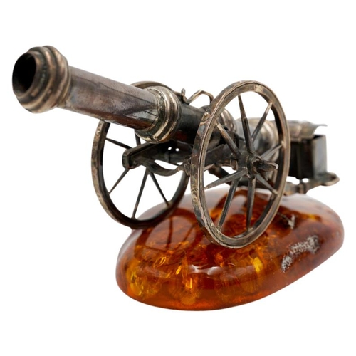 493 - SILVERED-METAL MINIATURE CANNON ON AN AMBER BASE20TH CENTURY10cm long approx.PROVENANCE : Private Ox... 