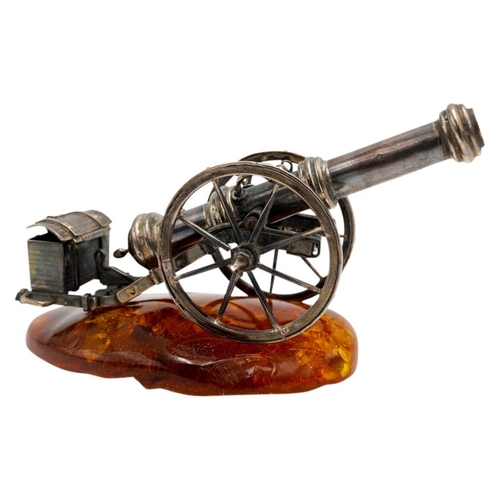 493 - SILVERED-METAL MINIATURE CANNON ON AN AMBER BASE20TH CENTURY10cm long approx.PROVENANCE : Private Ox... 