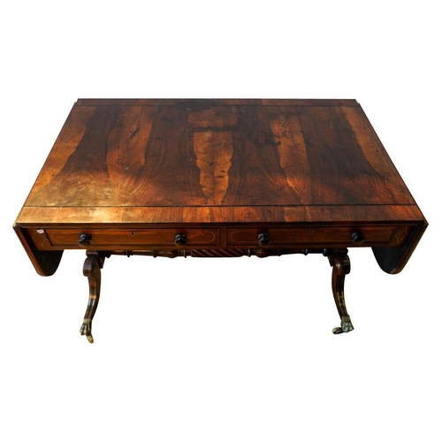 57 - GOOD REGENCY ROSEWOOD AND BRASS INLAID SOFA TABLECIRCA 1820the ebony line inlaid drop-leaf rounded r... 