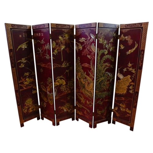 98 - RED LACQUER SIX-FOLD SCREENEARLY 20TH CENTURYwith gilt chinoiserie decorationeach fold, 40cm wide, 1... 