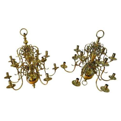 100 - NEAR PAIR OF DUTCH TWELVE-LIGHT BRASS CHANDELIERS19TH CENTURYthe multi-baluster shaft issuing two ti... 