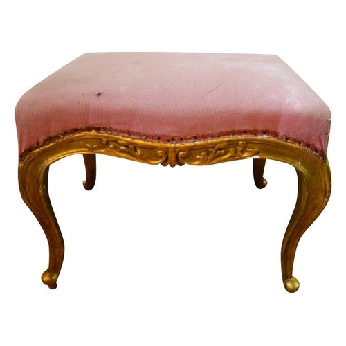 74 - LOUIS XV STYLE GILTWOOD STOOL19TH CENTURYthe serpentine padded seat covered in pink fabric, raised o... 