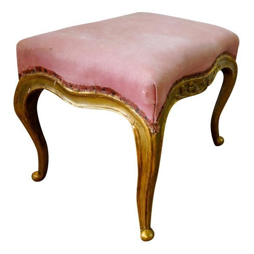 74 - LOUIS XV STYLE GILTWOOD STOOL19TH CENTURYthe serpentine padded seat covered in pink fabric, raised o... 