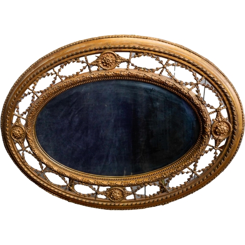 84 - VICTORIAN GILTWOOD AND GESSO OVAL WALL MIRROR19TH CENTURYthe oval plate within an ornate openwork fr... 