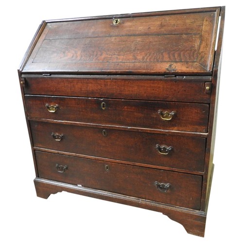 86 - GEORGE III OAK BUREAUCIRCA 1760the fall front enclosing a fitted interior with covered well, below a... 