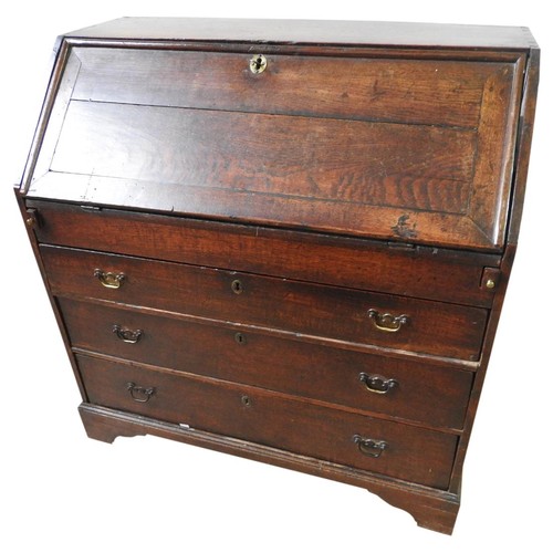 86 - GEORGE III OAK BUREAUCIRCA 1760the fall front enclosing a fitted interior with covered well, below a... 