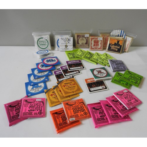 40 - ASSORTED GUITAR STRINGS, including packets of six and twelve string sets including Ernie Ball and va... 