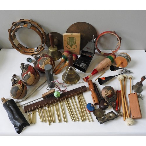 58 - A SELECTION OF VINTAGE PERCUSSION INSTRUMENTS to include cowbells, tambourines, a Kalimba, four... 