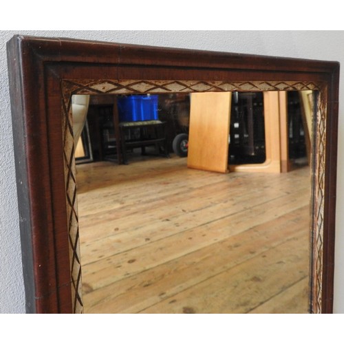 261 - A 19TH CENTURY MAHOGANY FRAMED WALL MIRROR, with painted cross hatch pattern border, 56 x 32cm