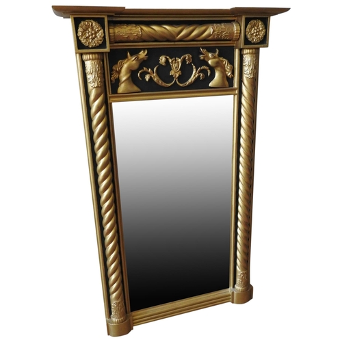 265 - A REGENCY GILT FRAMED AND EBONISED PIER MIRROR, with moulded rope twist pillars and a central panel ... 