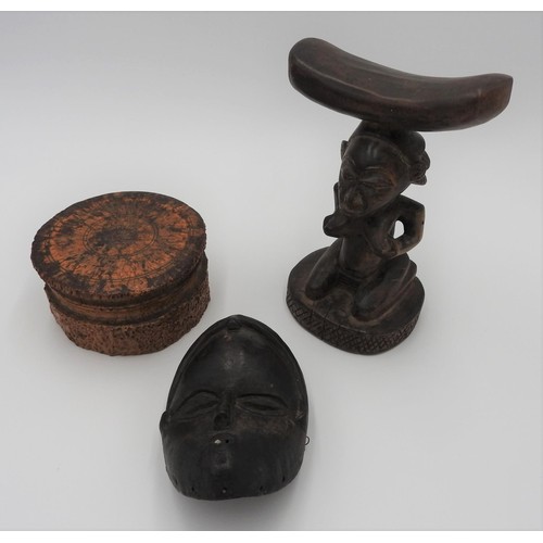 257 - A CARVED TREEN TRIBAL HEAD REST, CARVED WOODEN MASK AND A COVERED SOFT WOOD BOX, the head rest decor... 