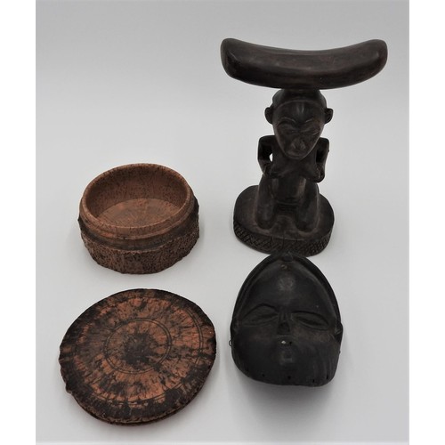 257 - A CARVED TREEN TRIBAL HEAD REST, CARVED WOODEN MASK AND A COVERED SOFT WOOD BOX, the head rest decor... 