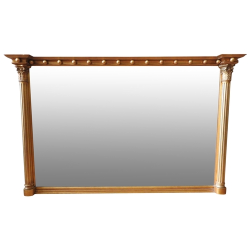 268 - A REGENCY STYLE GILT OVERMANTEL MIRROR, with ball frieze flanked by Corinthian columns. 128 x 84cms